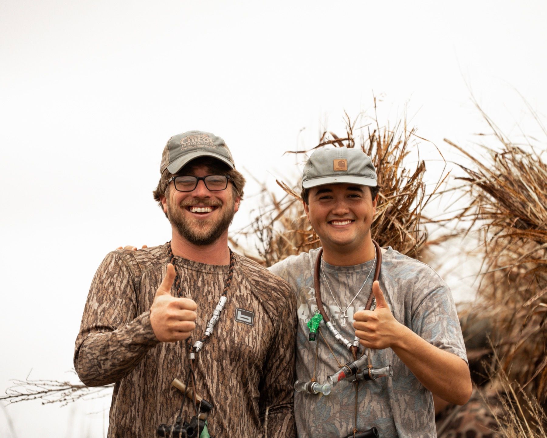 Two smiling hunters in camouflage after a Delta Outdoors Co. hunt.