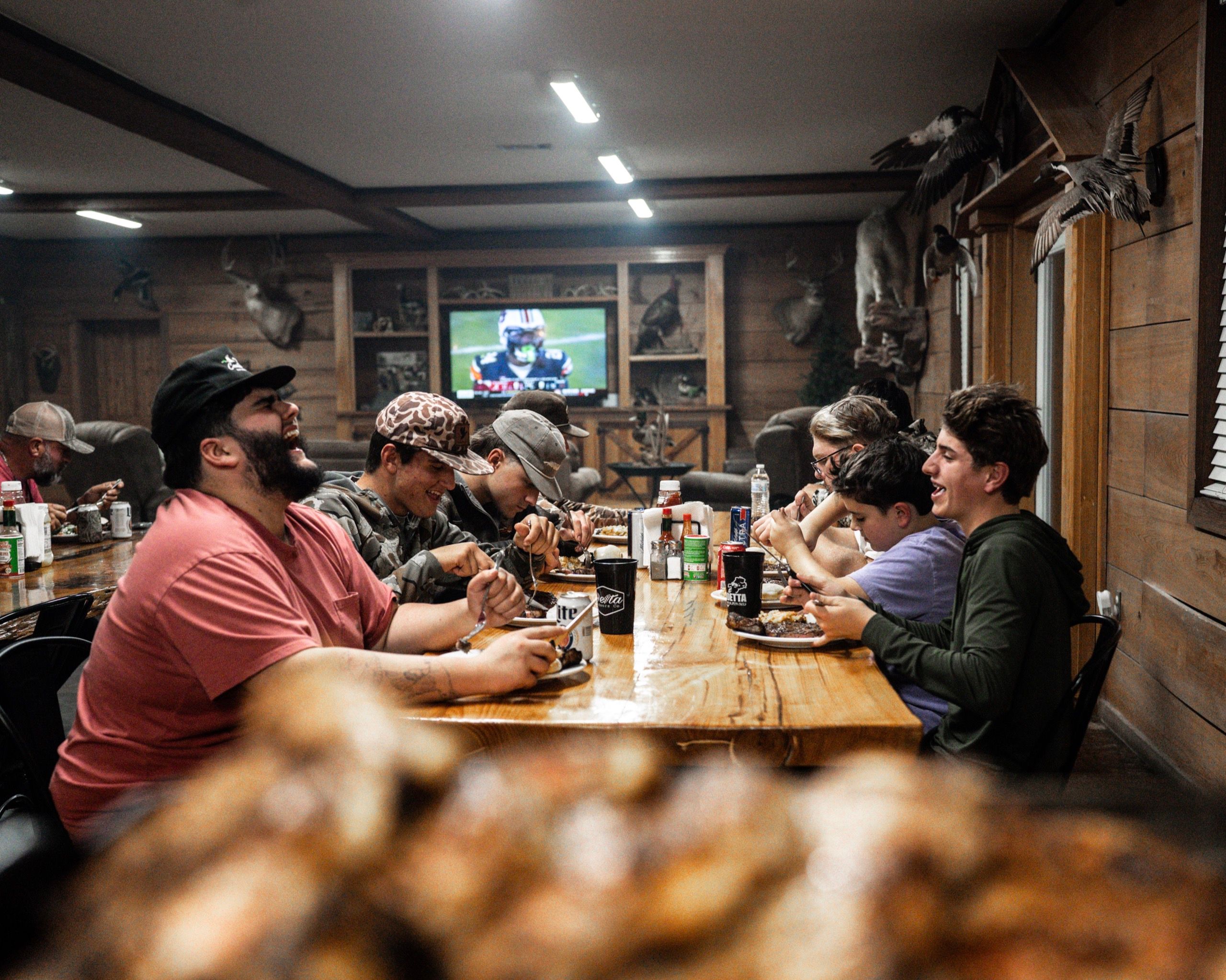Delta Outdoors Co. guests sharing a lodge dinner after an Arkansas waterfowl hunt.