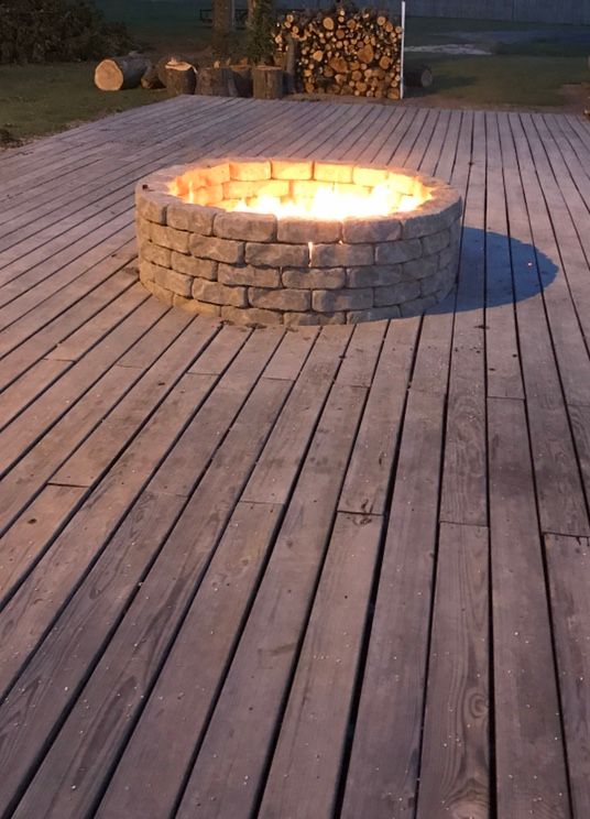 Outdoor fire pit on the Delta Outdoors Co. lodge deck for guests after a day of hunting.