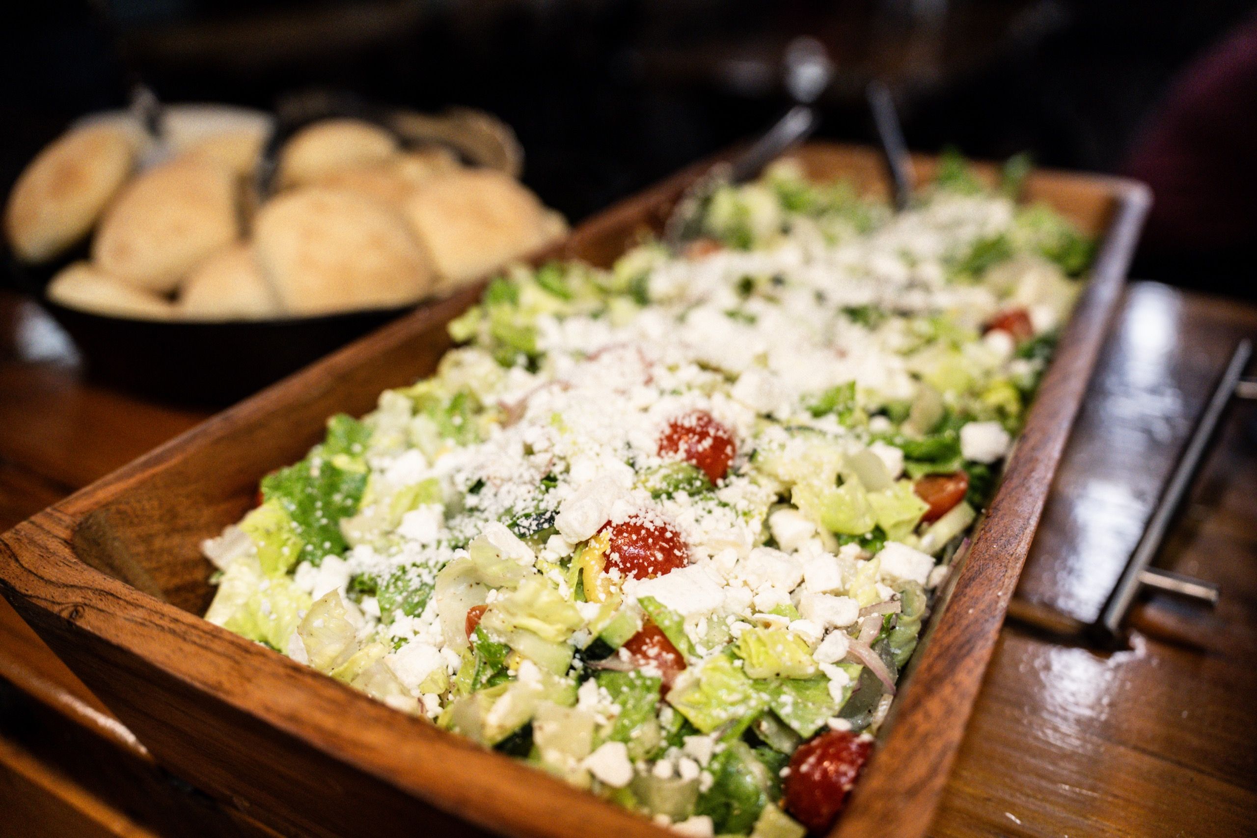 Fresh salad and dinner rolls served during a Delta Outdoors Co. lodge meal.