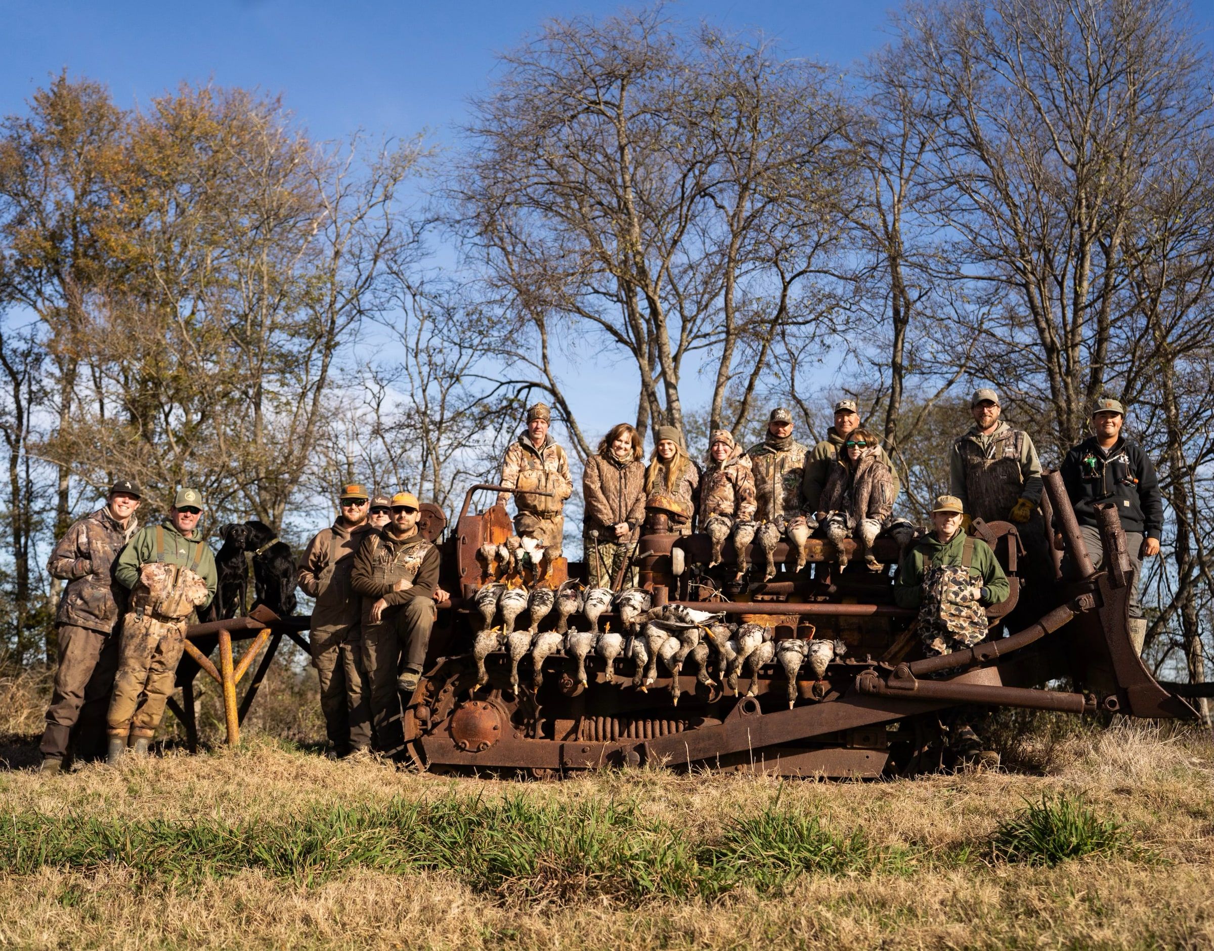 A large Delta Outdoors group posing around a bird rack after a successful hunt.