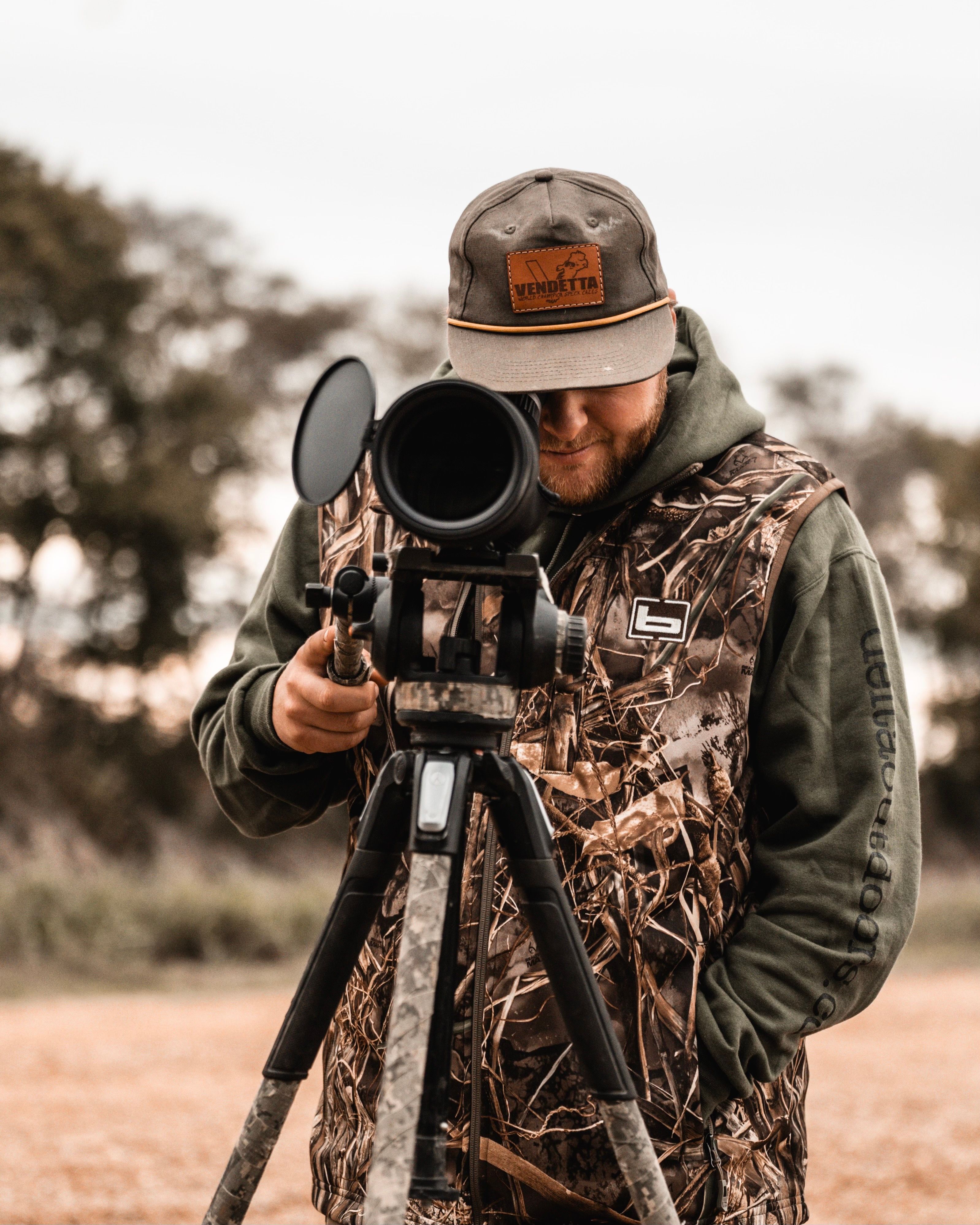 Delta Outdoors Co. hunter scouting through a field optic before the hunt.