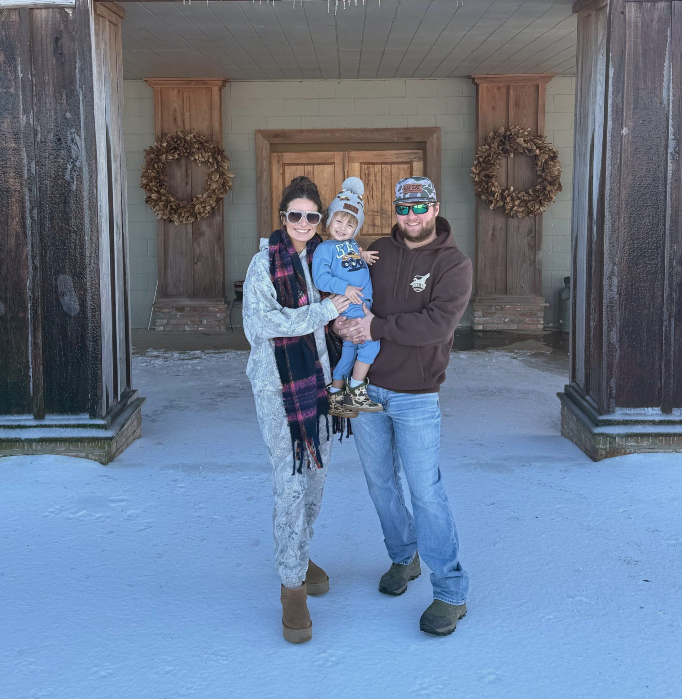 The Delta Outdoors Co. family standing at the lodge entrance.
